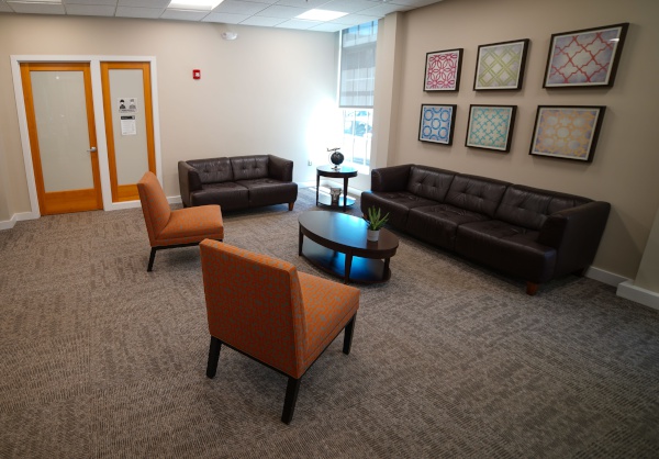 Waiting room with couch in Cambridgeside Dental