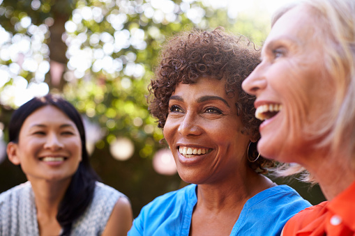 Group of smiling older women with dental implants from Cambridgeside Dental Associates in Cambridge, MA