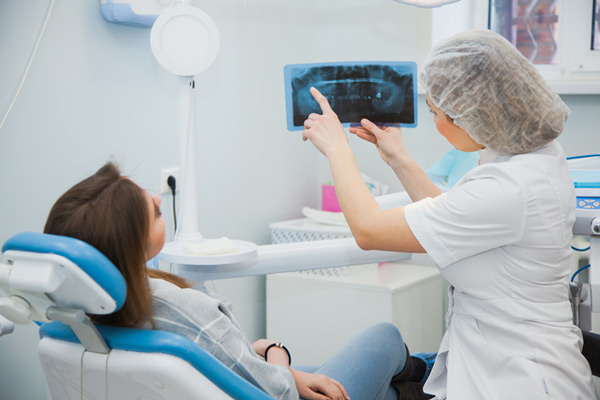 A woman being shown x rays before bone grafting procedure 