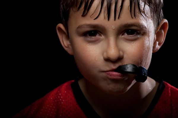 Sweaty boy with mouthguard in his mouth