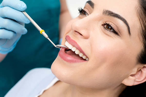 A woman receiving a dental exam at Cambridgeside Dental Associates in Cambridge, MA 