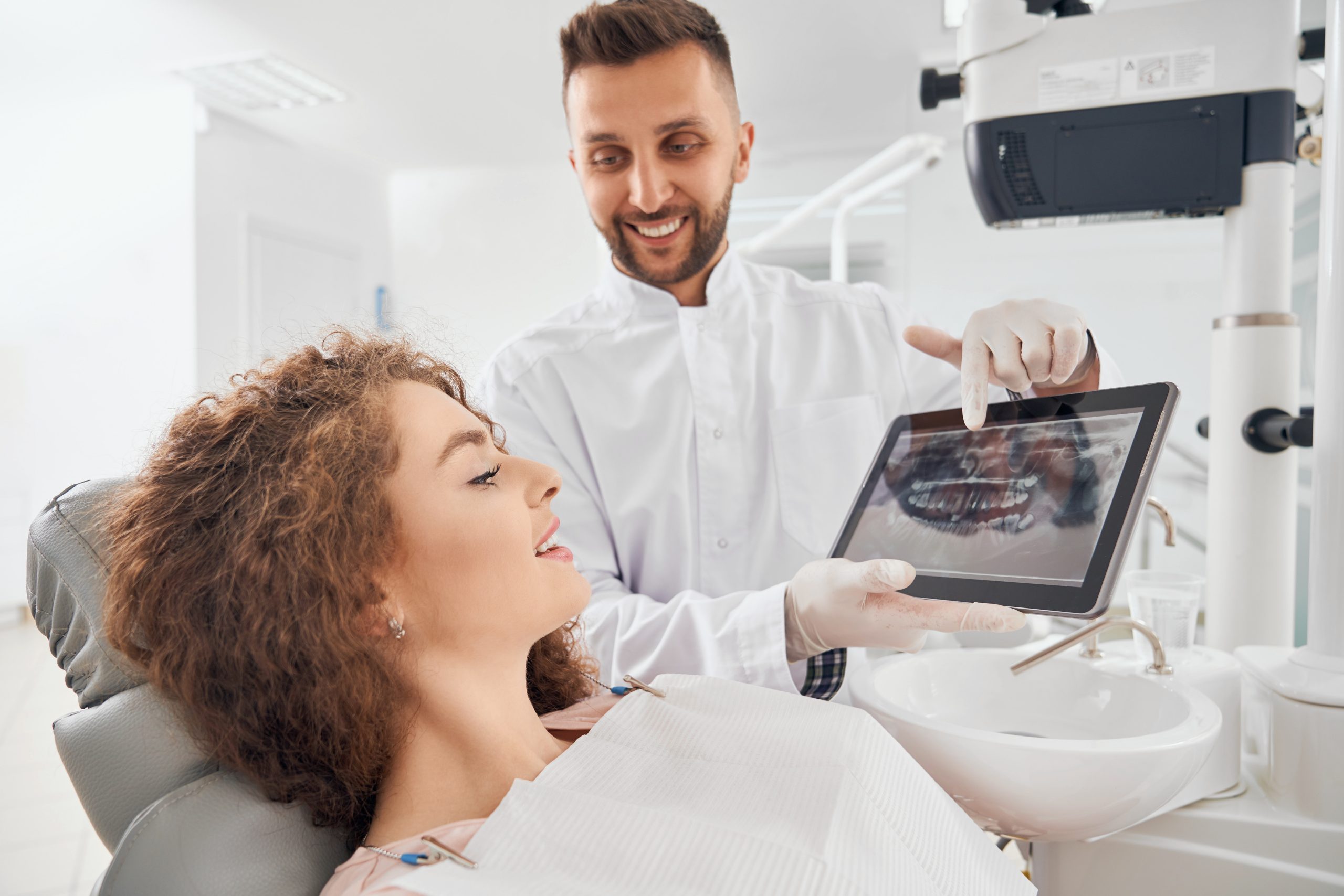 Doctor showing xray pictures teeth tablet scaled.